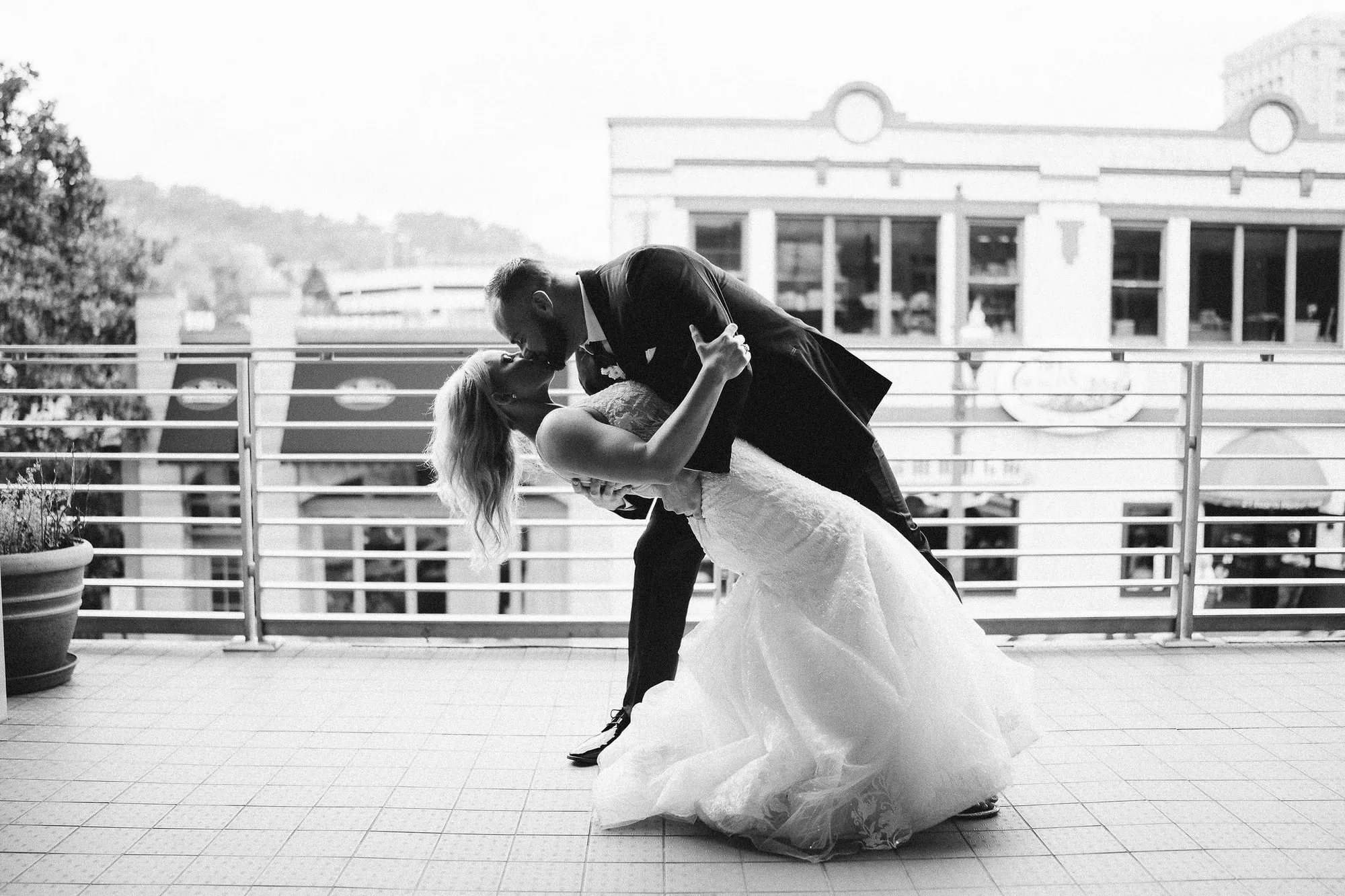 A couple on the open-air balcony, the Asheville streetscape behind them